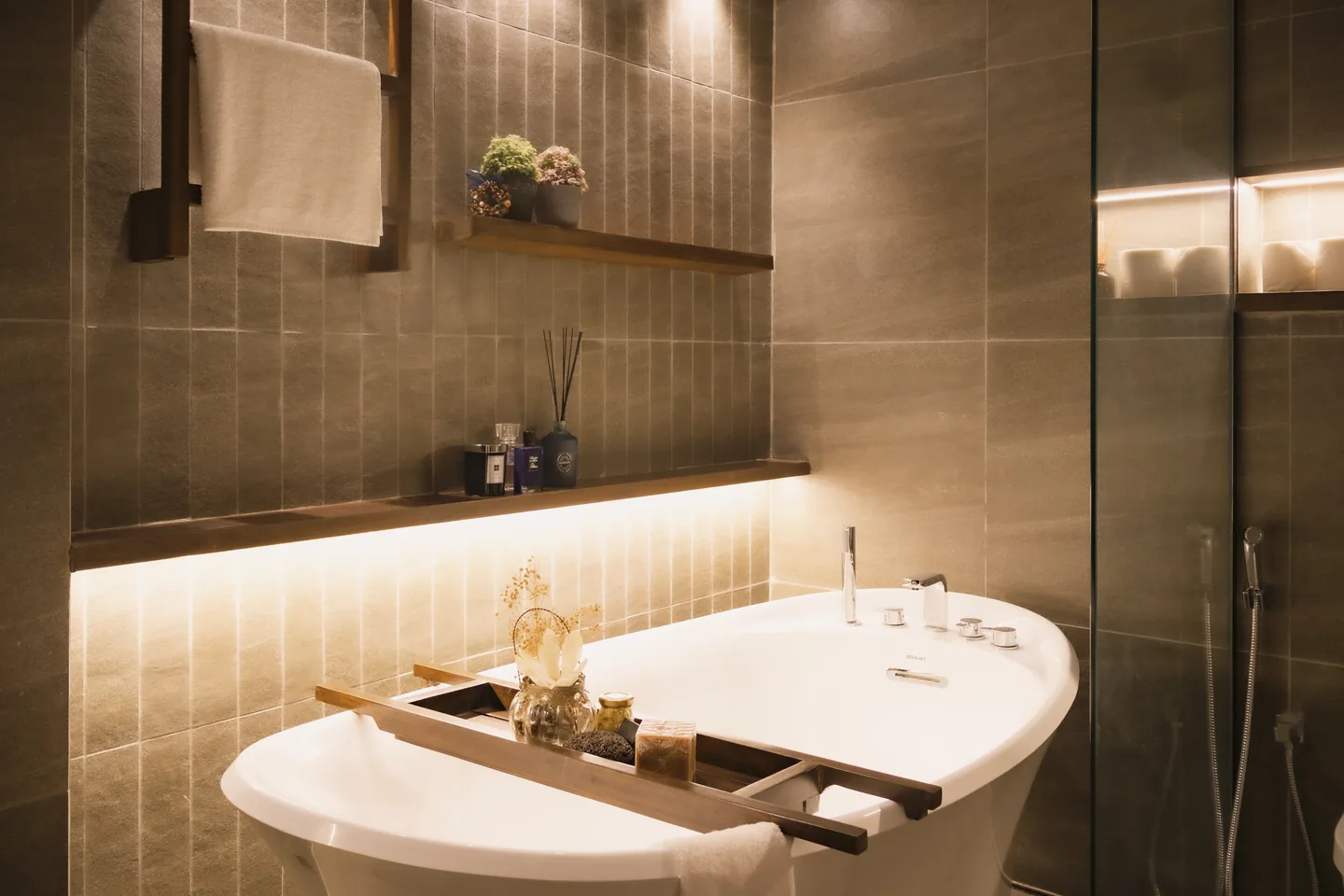 A softly lit spa-like bathroom with a freestanding bath at Getaway Home