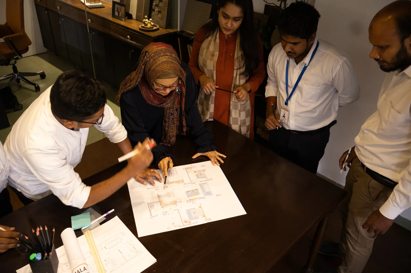 The MDA team reviewing architectural plans together
